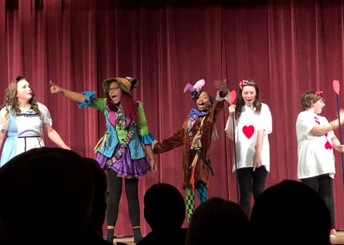 Students perform Alice in Wonderland in costume