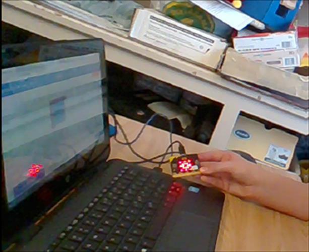A close-up of the microbit and a laptop computer