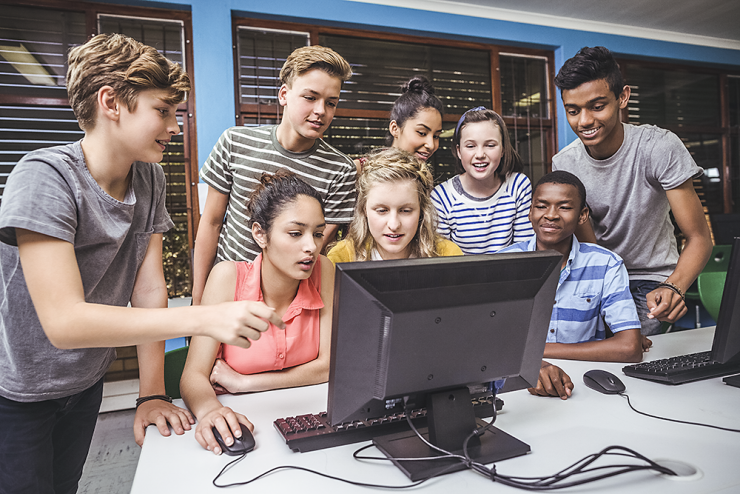 smiling-students-studying-together-in-computer-cla-V4WQT55.png