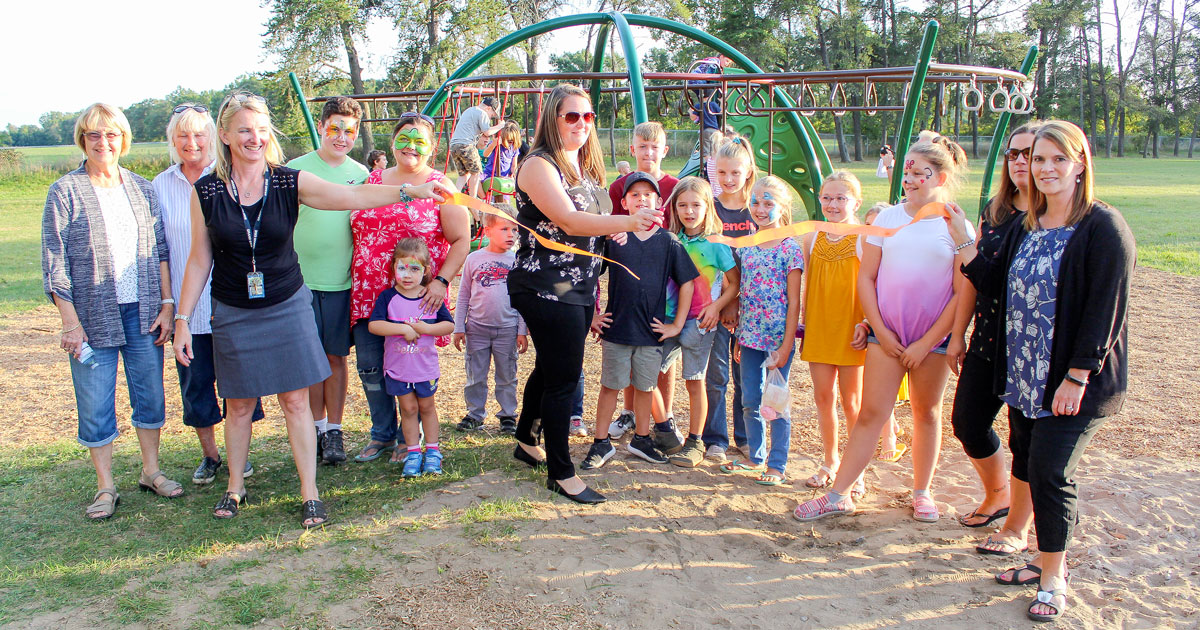 Langton School staff, students, and the Parents Council cut a ribbon to mark the official opening of the playground.