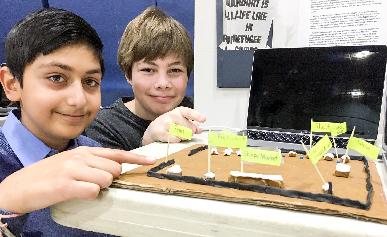 Tejan and William show off the details of the model they built.