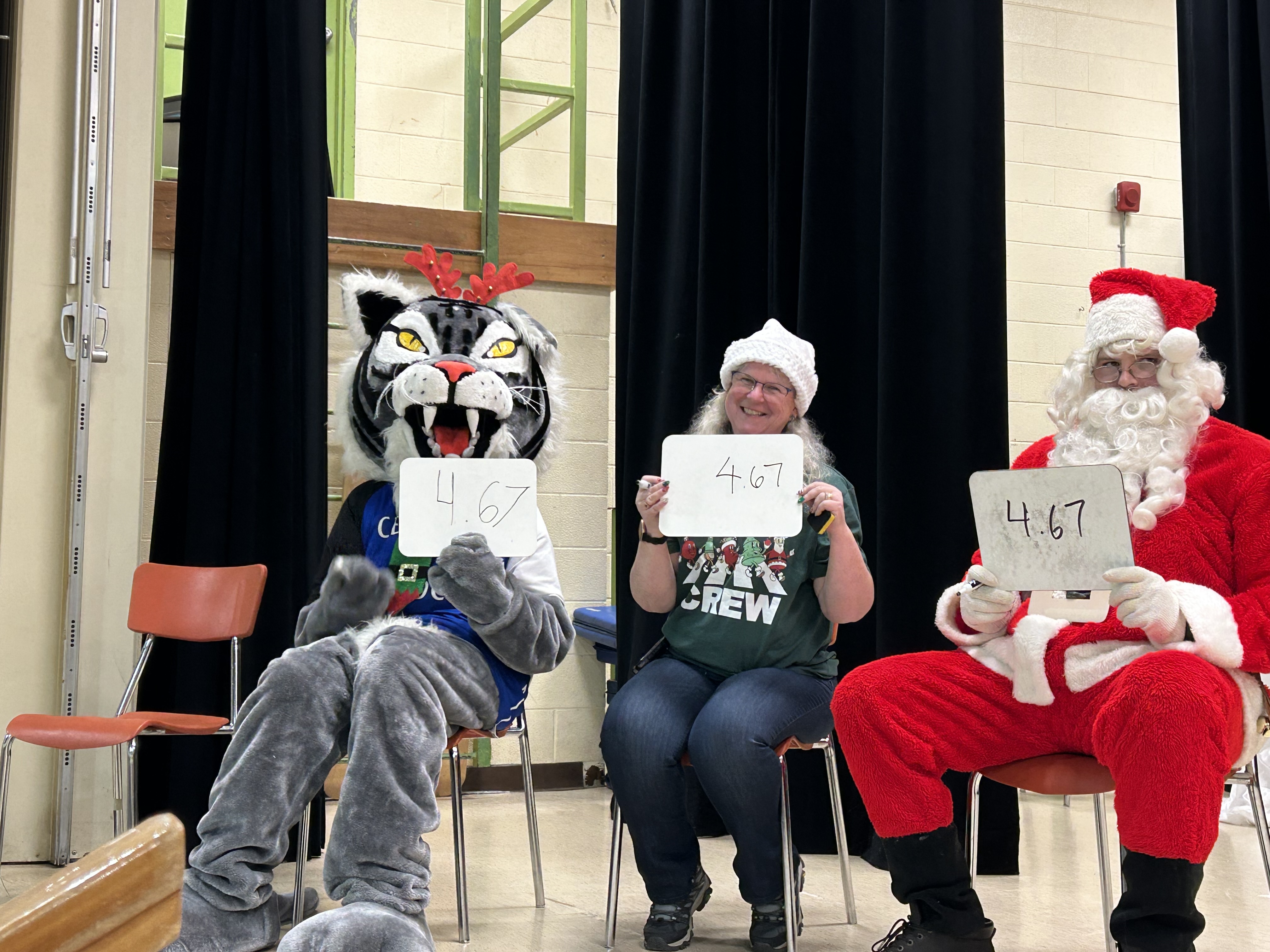 Cedar the Wildcat, Mrs. Ash and Santa judging the decorate the teacher event 