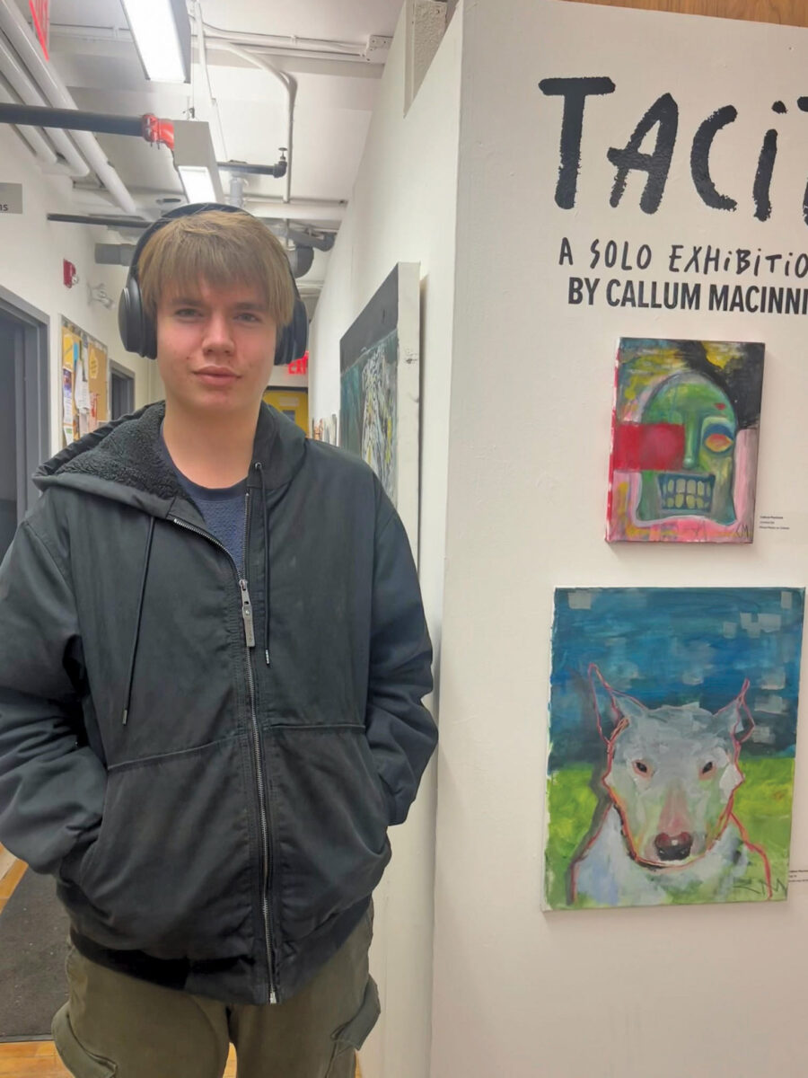 MPSS student Callum MacInnis poses for a photo on the opening night of his solo art exhibition