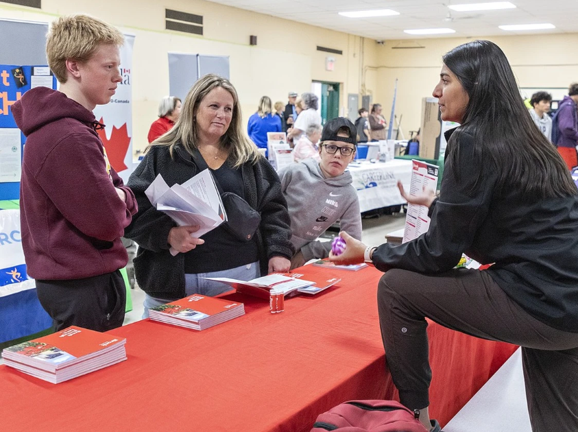 Screenshot 2025-11-05 153001 Melissa Freeman and her sons Mylz, age 16, (left) and Madden, 11, chat with Brock University recruitment officer Noor Mahmood during a Grand Pathways event at North Park Collegiate on October 29, 2025 in Brantford. Photo by Brian Thompson /The Expositor