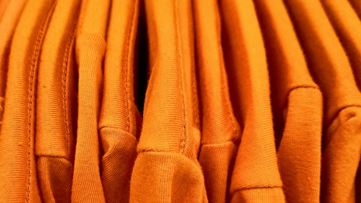 A collection of orange tshirts.