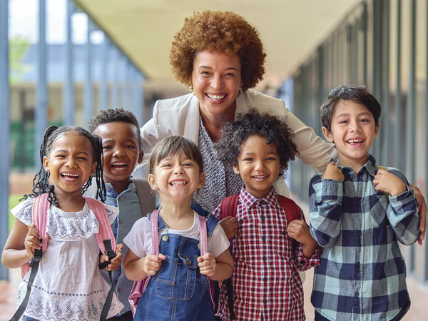 Smiling students outside a school