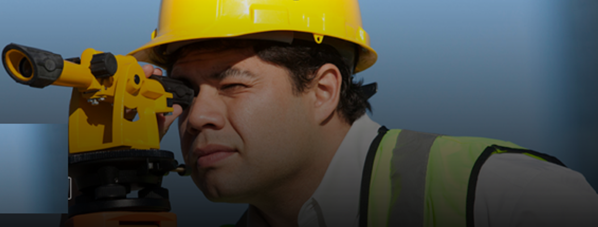 Construction worker looking to land surveyor tool