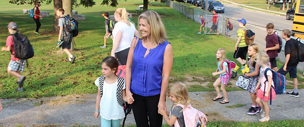 Parent standing with their children