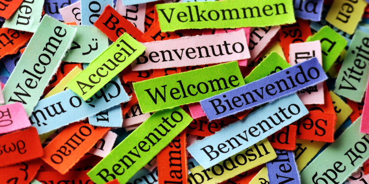 Collage of slips of paper with Welcome in different languages