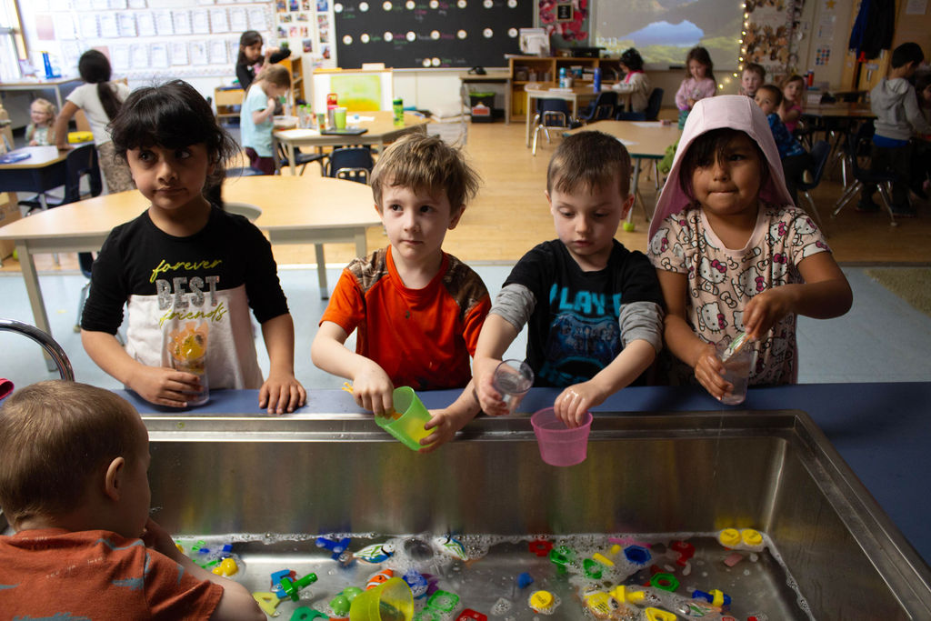 Kids playing at a water table