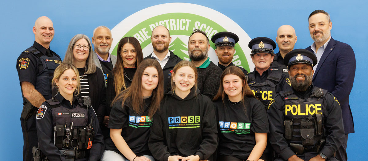 Students pose with Grand Erie staff and senior administrators, along with members of the Brantford Police Service