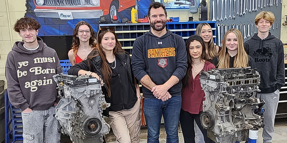 Dunnville Secondary School students surround a recent engine parts donation from Ford Canada