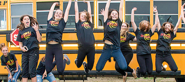 Students Jumping in front of a bus