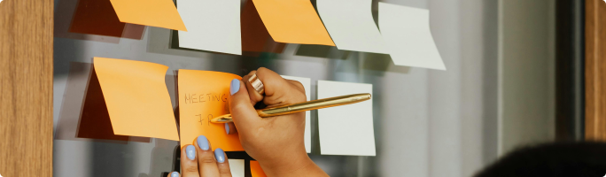 a sticker on a panel and a hand is writing something on it