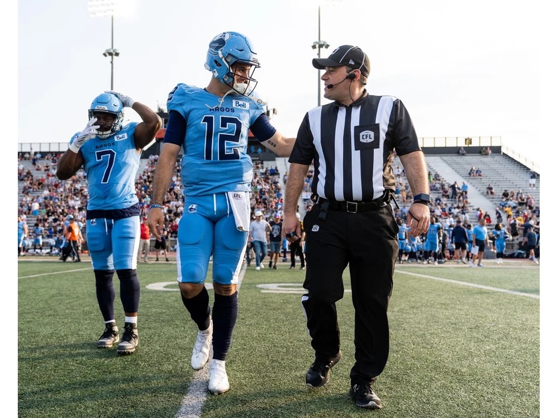 Brantford resident Marc Cobb, with Toronto Argonauts quarterback Chad Kelly, recently officiated in the CFL's Grey Cup.