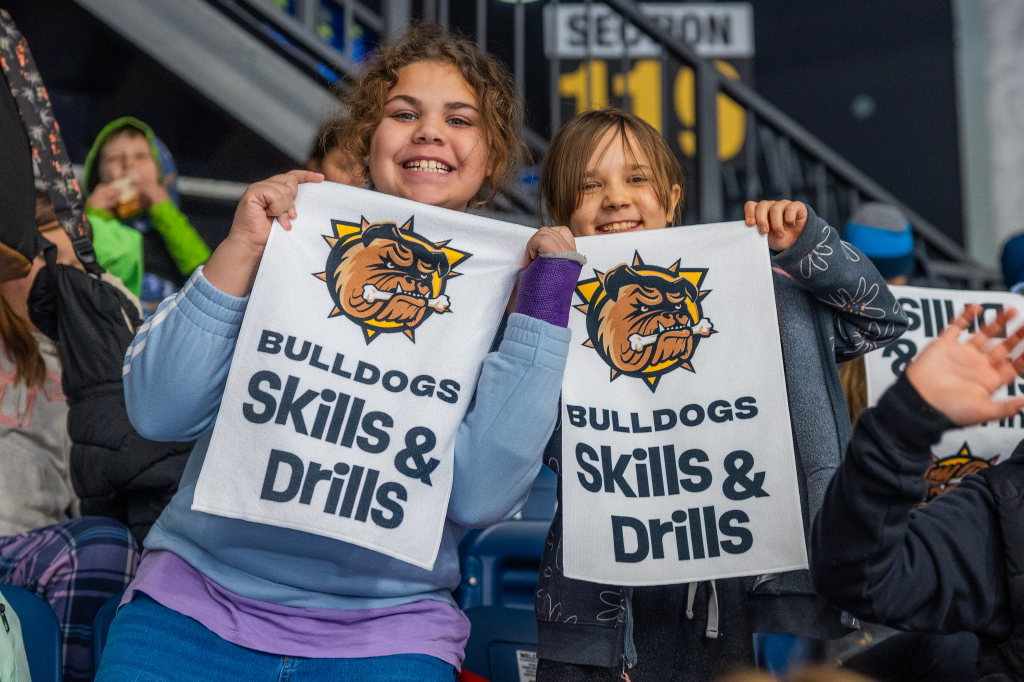 54947222987_538624b390_k Two students holding up rally towels at the Bulldogs Skills Competition.