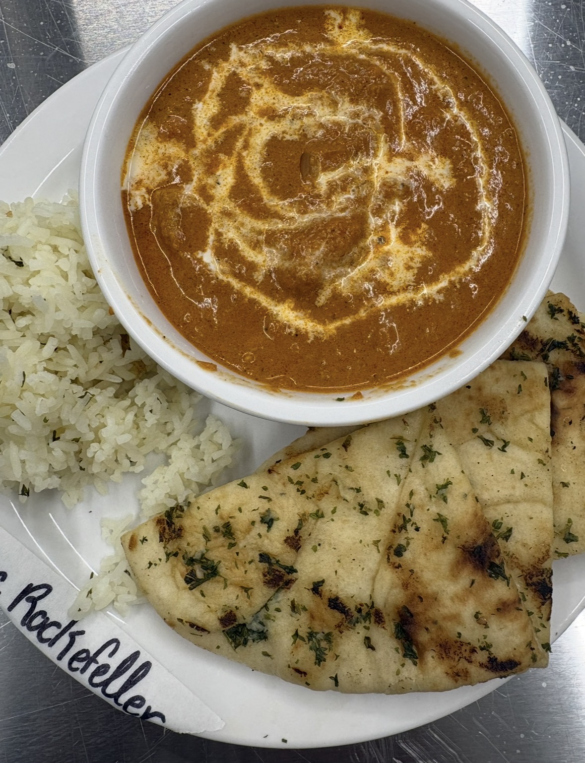 Butter chicken with naan bread and rice