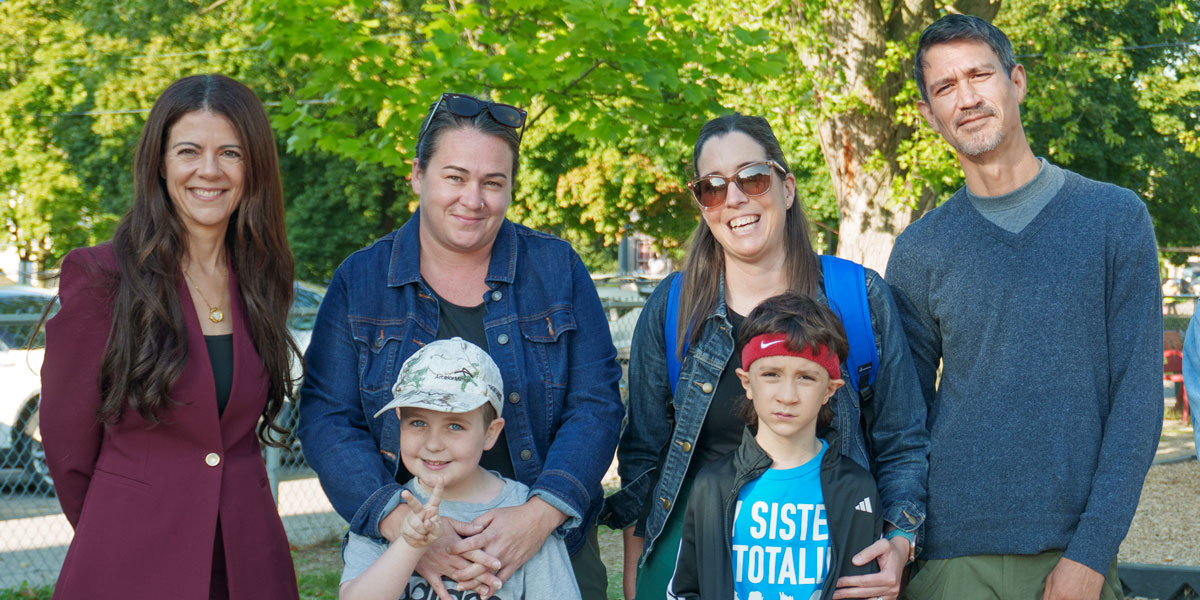 Parents, students and Director Roberto pose for a photo on the first day of school at Paris Central Public School