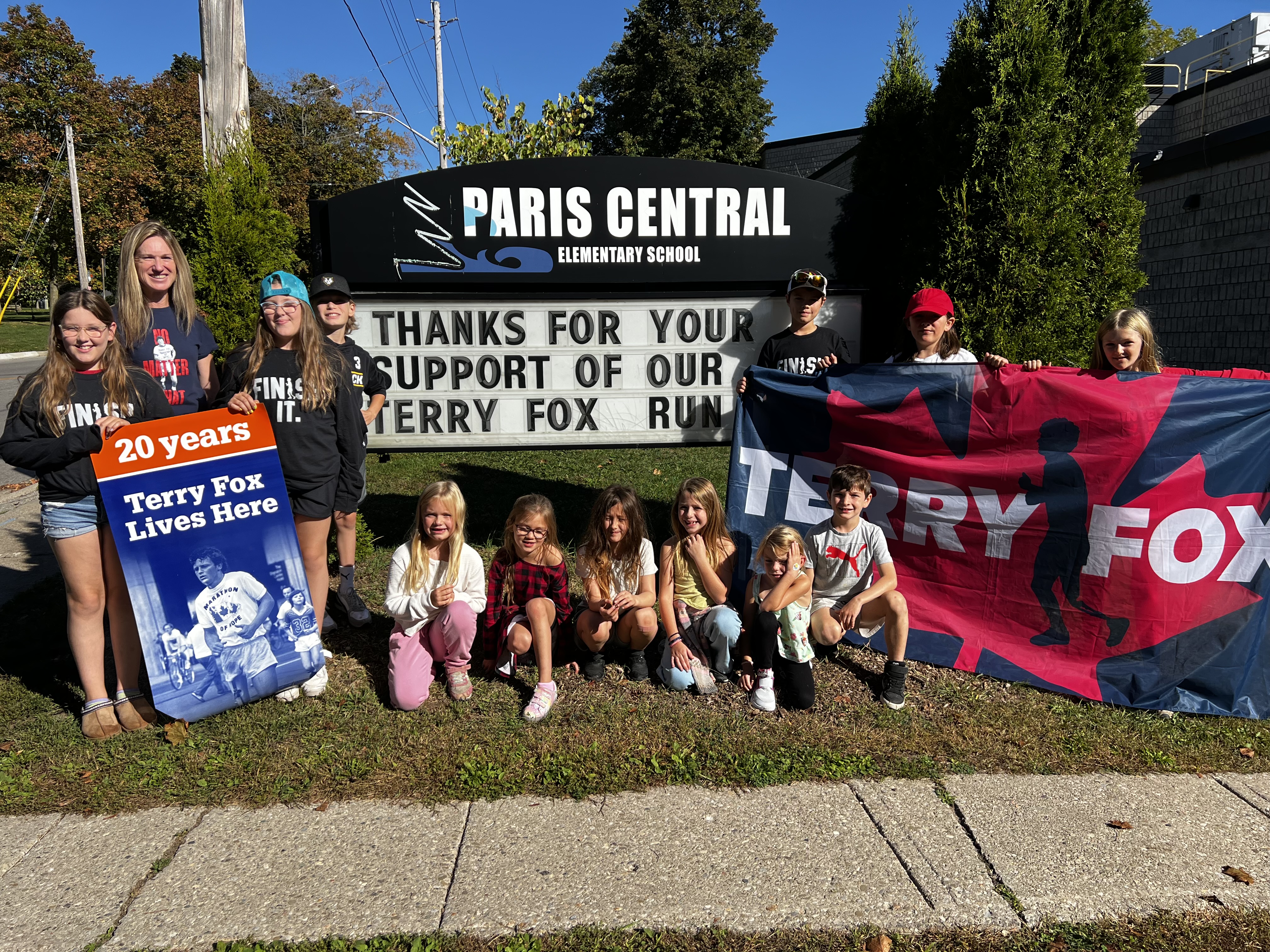 Ms. Sarkissian stands proudly with members of the Terry Fox Crew in front of Paris Central School,  where students and staff came together to raise more than $7,200 for cancer research during this  year’s Terry Fox Run.