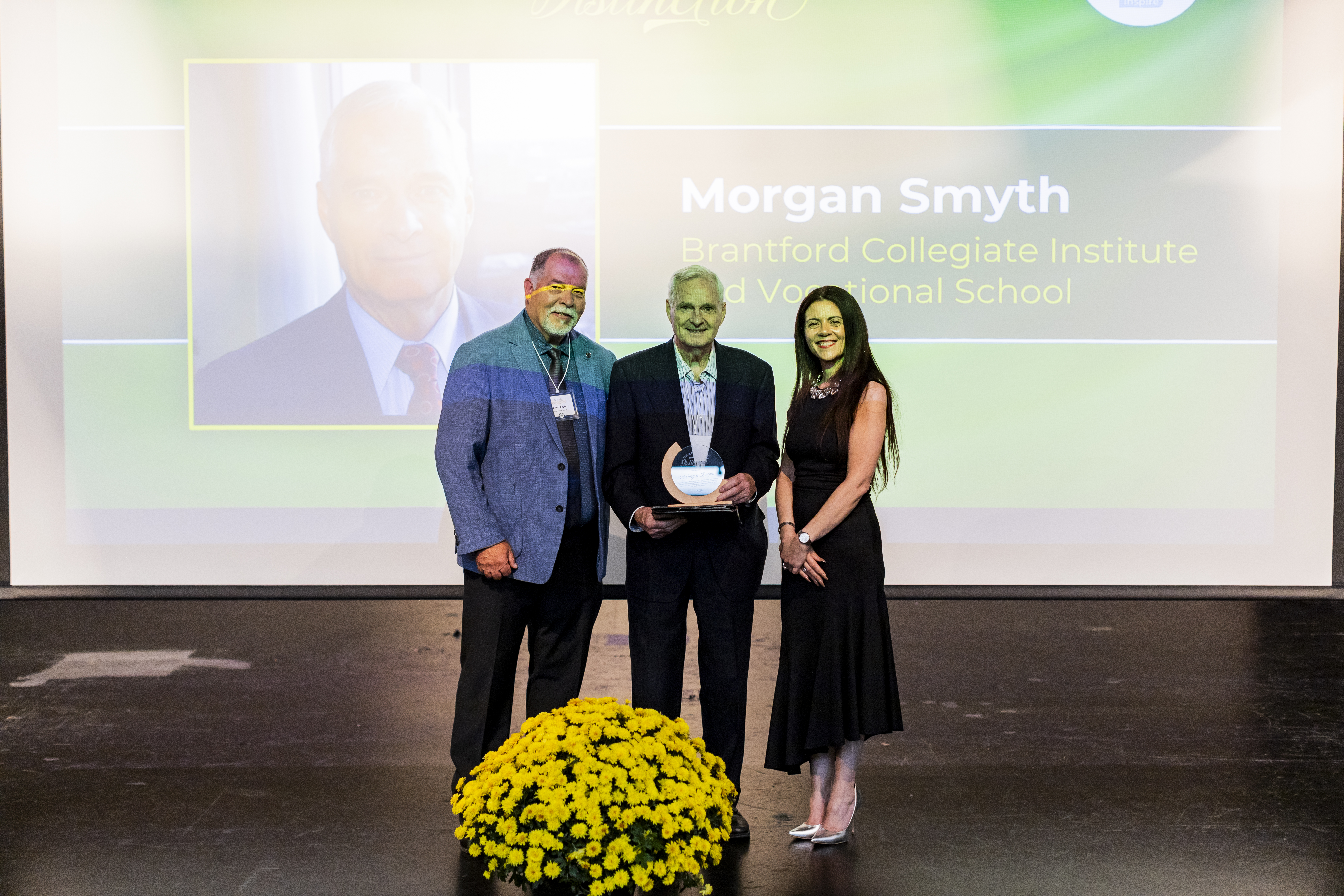 Morgan Smyth receiving award Morgan Smyth holding Hall of Distinction Award