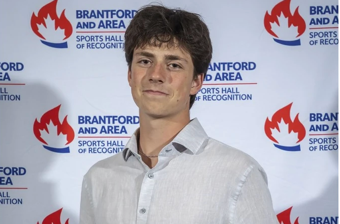 Paris District High School's Canaan Sherbino posing for a photo holding Ed O'Leary Memorial Award plaque as Brant County's top male high school student athlete.