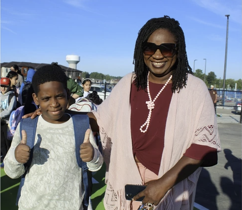 ​​Lucy Ruth Ziriro and her son Levi wait outside the new Blanche E. Williams Public School in Brantford where Levi started Grade 6 on September 8.