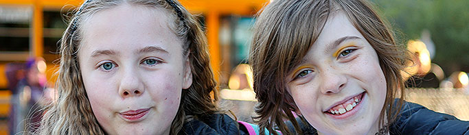 Two elementary students smile at the camera