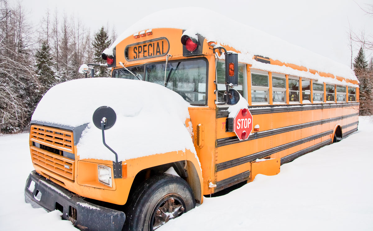 a school bus covered in snow