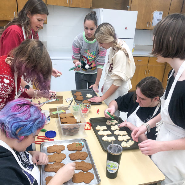 a group of girls baking cookies