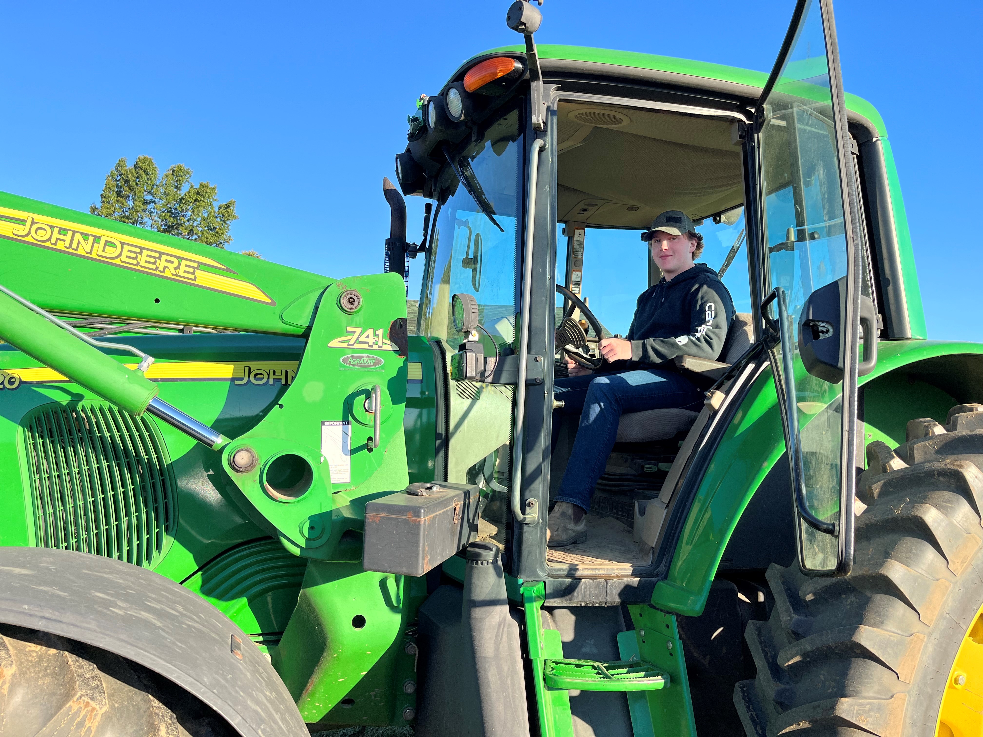 Student in the SHSM agriculture program riding a tractor