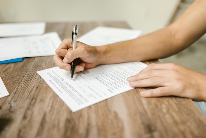 Student writing on paper