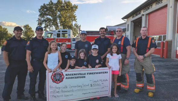 Hagersville Firefighters Association presenting cheque to students for new playground
