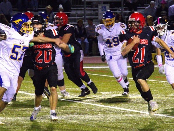 1011-br-hsfootball1.br_ Paris District High School's Ian Souliere runs past Brantford Collegiate Institute defenders during AABHN senior football action at Bisons Alumni North Park Sports Complex on Thursday. Brian Smiley Photo by Brian Smiley /Brian Smiley