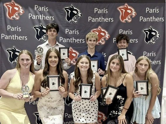 Students at Paris District's athletic banquet Award winners posing with trophies and plaques